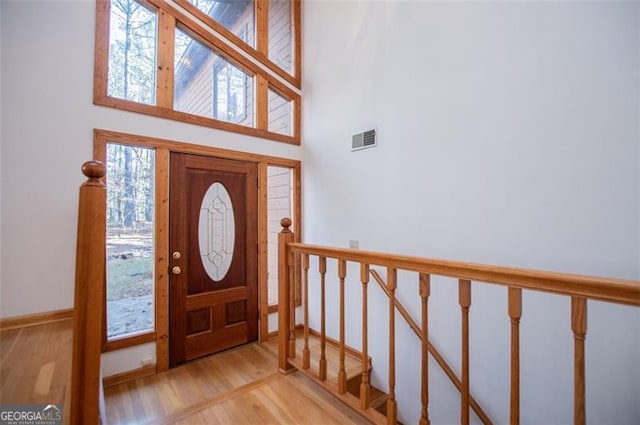 entrance foyer featuring light wood-type flooring and a high ceiling