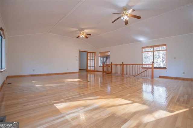 unfurnished room with ceiling fan, light hardwood / wood-style flooring, and lofted ceiling