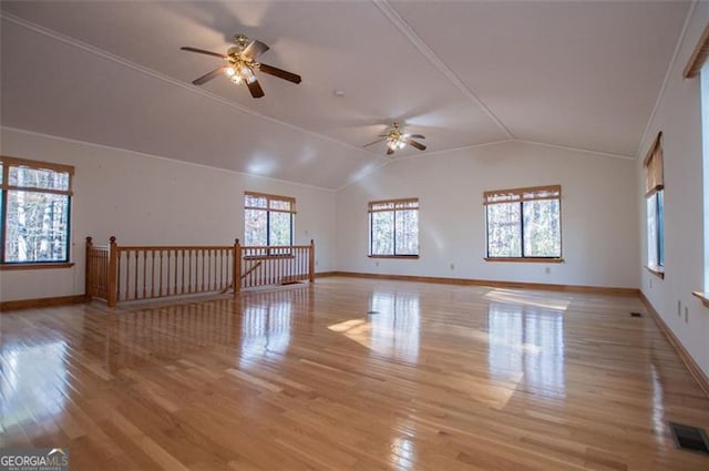 spare room featuring ceiling fan, vaulted ceiling, and light wood-type flooring