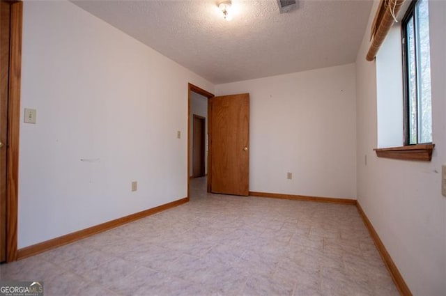 spare room featuring a textured ceiling