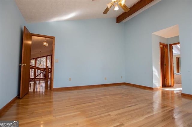 empty room with lofted ceiling with beams, light hardwood / wood-style floors, and ceiling fan with notable chandelier