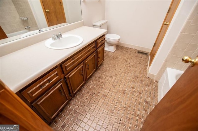 bathroom featuring tile patterned floors, vanity, and toilet