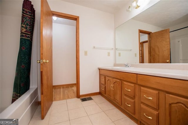 bathroom featuring vanity, tile patterned floors, and shower / bathtub combination with curtain