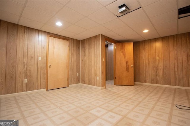 basement featuring wooden walls