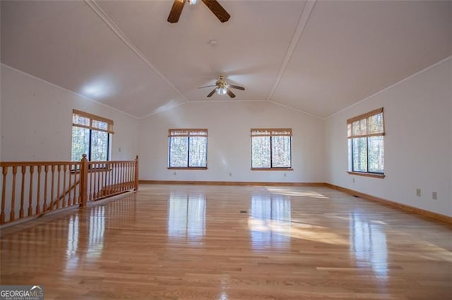 empty room featuring light hardwood / wood-style floors, plenty of natural light, lofted ceiling, and ceiling fan