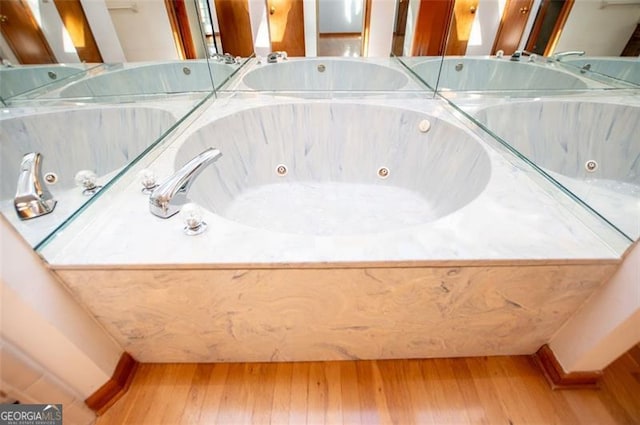 bathroom with hardwood / wood-style floors and a bathtub