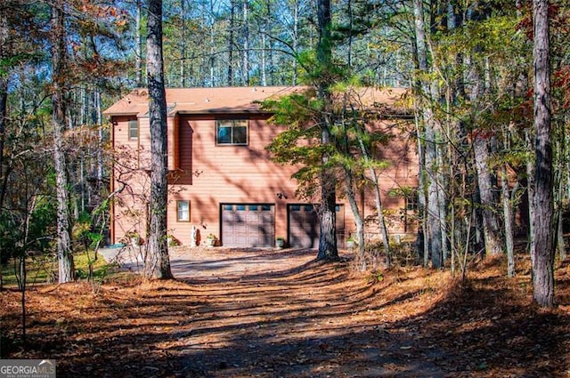 back of house featuring a garage