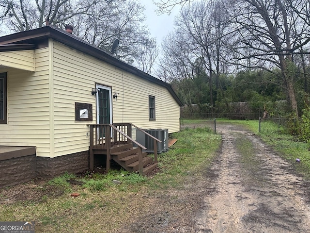 view of side of home with central AC unit