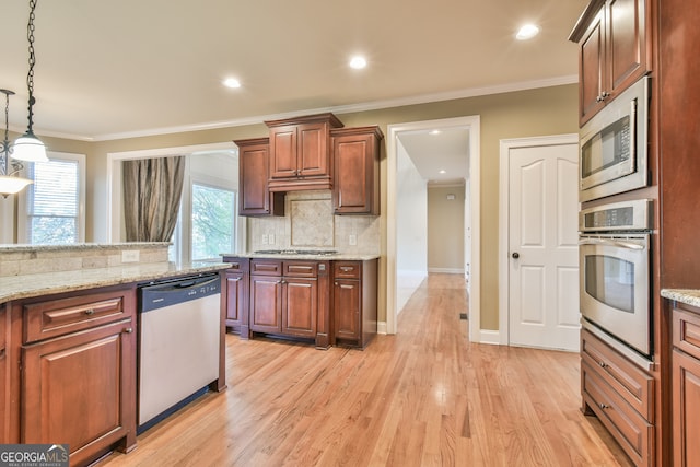 kitchen with ornamental molding, decorative light fixtures, light hardwood / wood-style floors, light stone counters, and stainless steel appliances