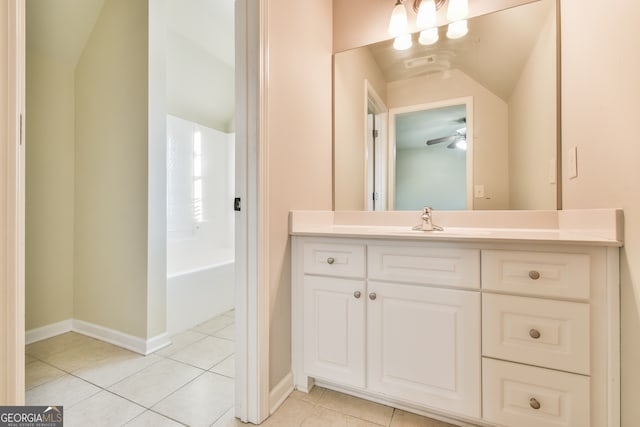 bathroom featuring tile patterned flooring, vanity, vaulted ceiling, and ceiling fan