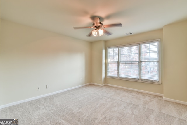 spare room with light carpet and ceiling fan