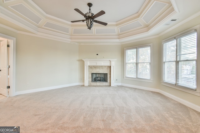 unfurnished living room featuring a high end fireplace, light carpet, ceiling fan, and ornamental molding