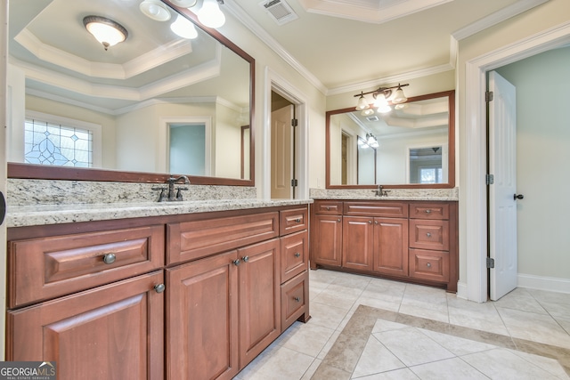 bathroom featuring a raised ceiling, crown molding, tile patterned flooring, and vanity