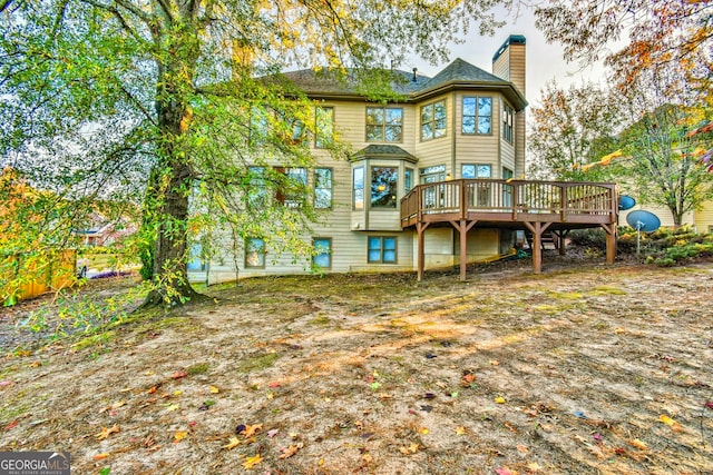 rear view of property with a wooden deck