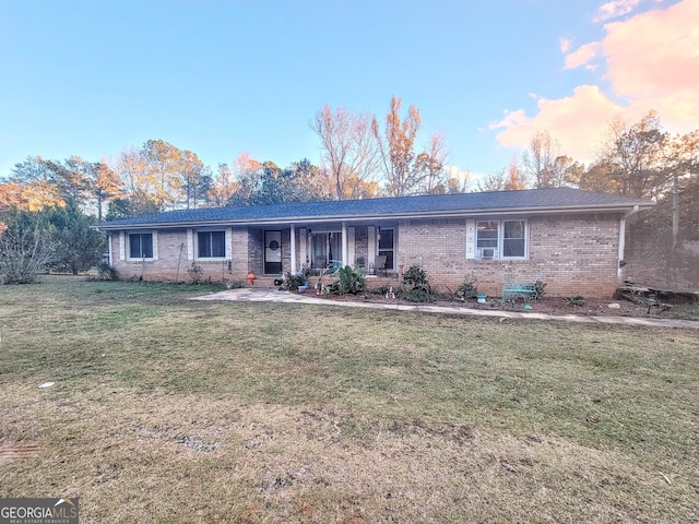 ranch-style home with a yard