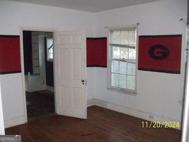 empty room with dark hardwood / wood-style flooring