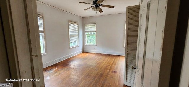 unfurnished bedroom featuring hardwood / wood-style flooring, ceiling fan, and ornamental molding