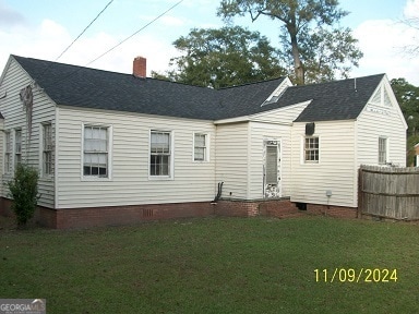 back of house with a lawn