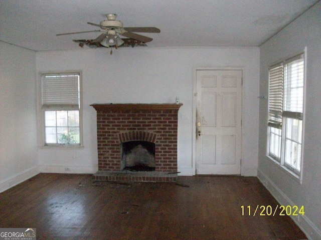 unfurnished living room featuring ceiling fan, a fireplace, and dark hardwood / wood-style floors