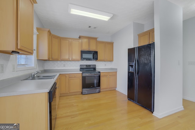 kitchen featuring light hardwood / wood-style flooring, sink, light brown cabinets, and black appliances