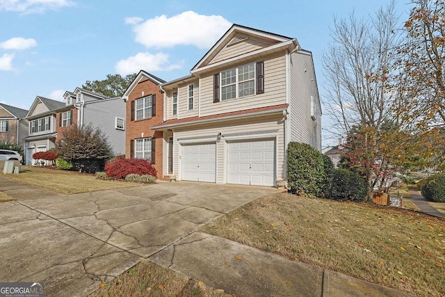 view of front property featuring a garage and a front lawn