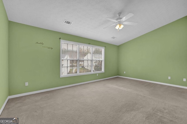 unfurnished room featuring ceiling fan, carpet floors, and a textured ceiling