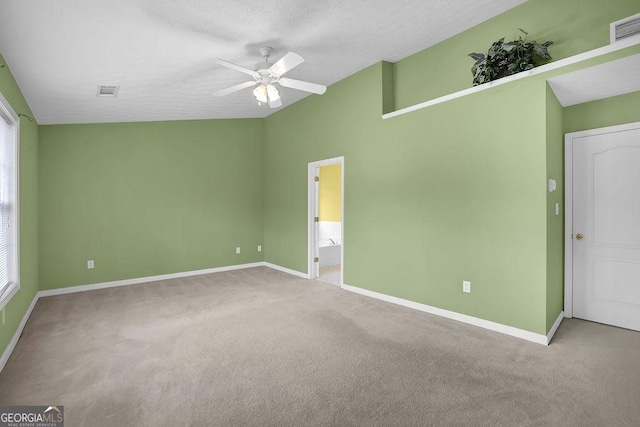 empty room featuring ceiling fan, carpet floors, and a textured ceiling