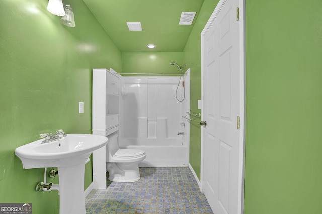 bathroom featuring shower / bathing tub combination and toilet