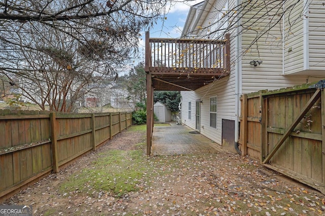 view of yard with a storage shed and a patio area