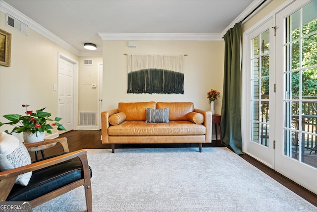 living room with crown molding and dark wood-type flooring