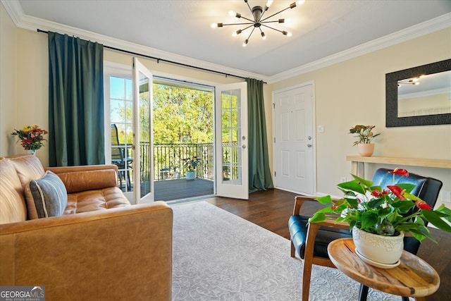 living room with a chandelier, dark hardwood / wood-style flooring, and crown molding