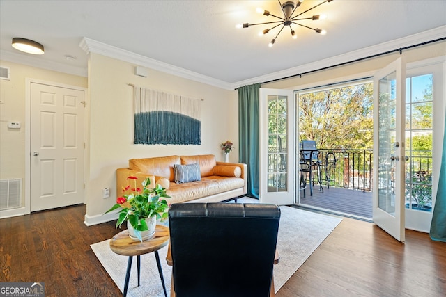 living room featuring french doors, a chandelier, dark hardwood / wood-style floors, and ornamental molding