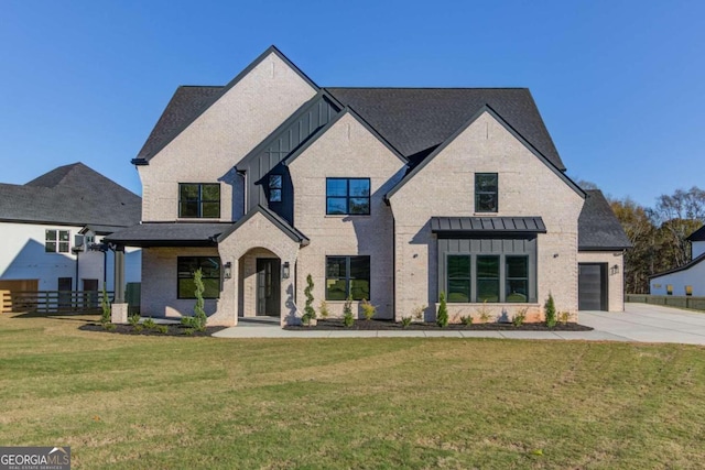 view of front of home featuring a garage and a front yard