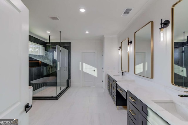 bathroom with tile patterned flooring, vanity, and walk in shower