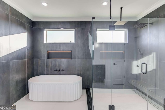 bathroom featuring shower with separate bathtub, ornamental molding, and tile walls