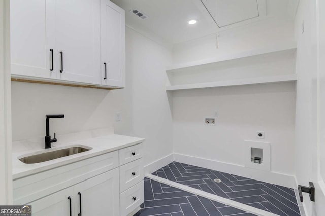 laundry room with sink, cabinets, electric dryer hookup, hookup for a washing machine, and dark tile patterned flooring