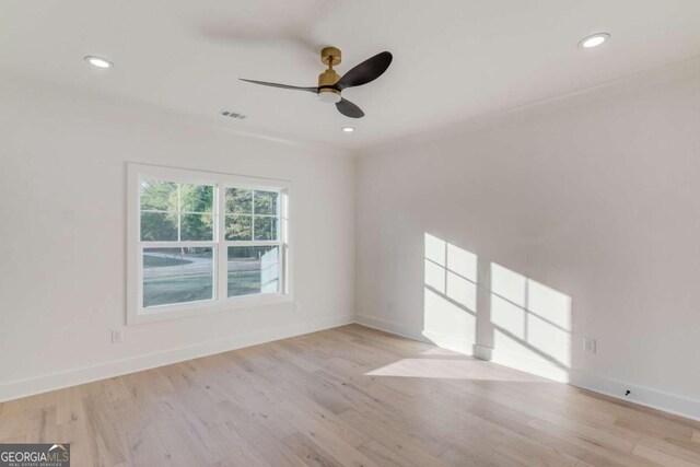 spare room featuring light hardwood / wood-style floors and ceiling fan