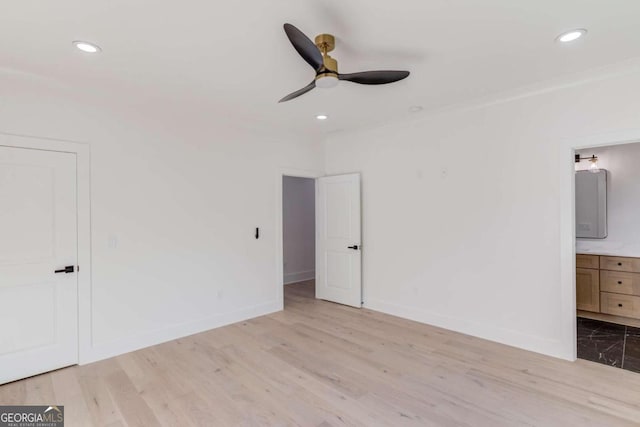 unfurnished bedroom featuring ensuite bathroom, ceiling fan, and light hardwood / wood-style floors