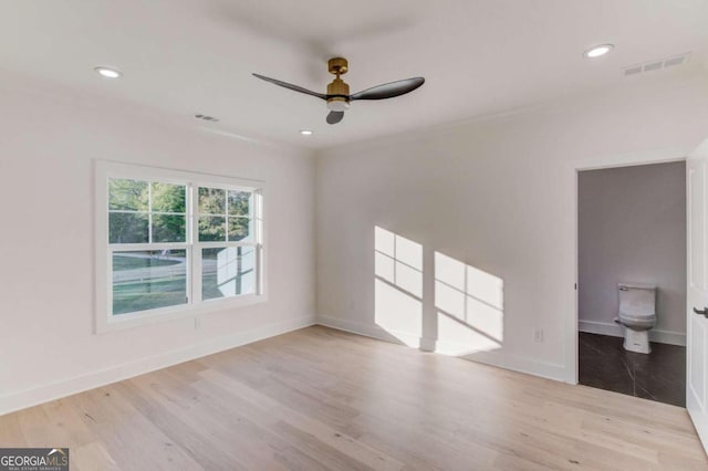 empty room featuring light wood-type flooring and ceiling fan