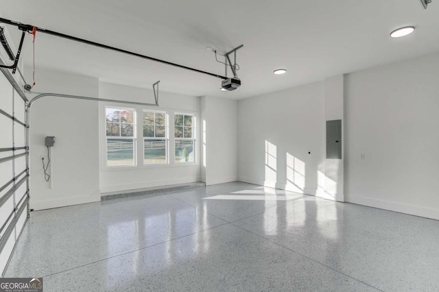 garage with electric panel and a garage door opener