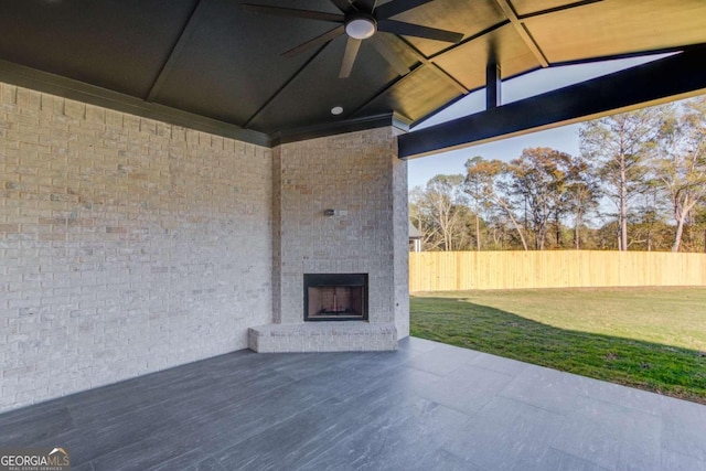 view of patio featuring an outdoor brick fireplace and ceiling fan