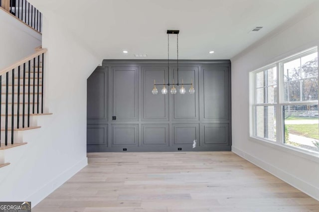 unfurnished dining area with a healthy amount of sunlight and light wood-type flooring