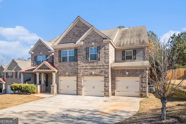 craftsman-style home featuring central AC and a garage