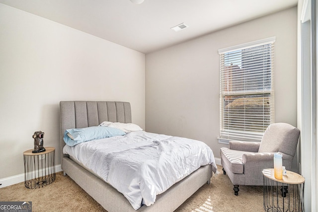 bedroom featuring light colored carpet