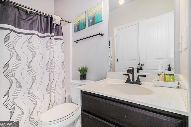 bathroom featuring vanity and toilet