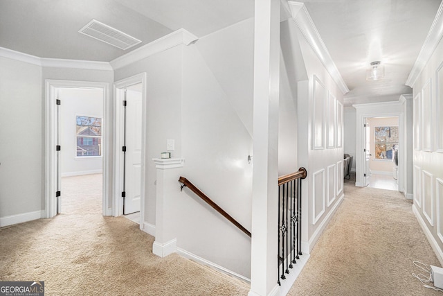 corridor featuring light carpet and crown molding