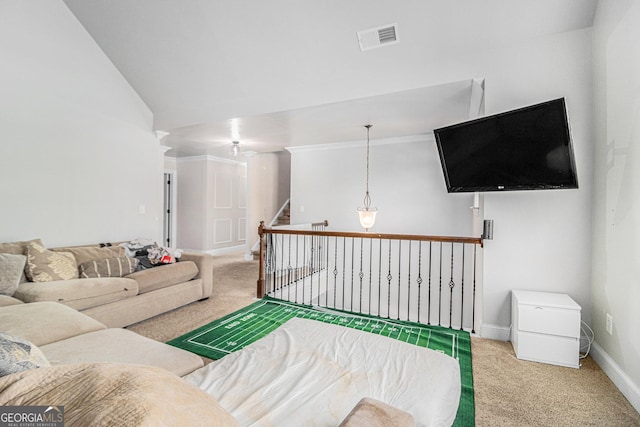 living room featuring carpet, lofted ceiling, and ornamental molding