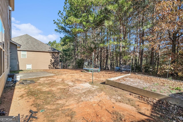 view of yard featuring a patio and a trampoline