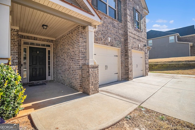 view of exterior entry with a garage