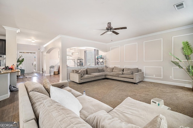 living room with ceiling fan, wood-type flooring, and ornamental molding